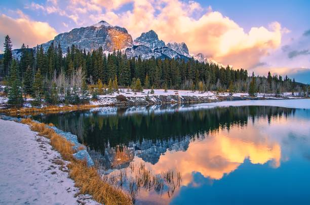 istock Sunrise Clouds Glowing Over A Wintry Quarry Lake Park 1355699430