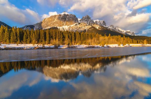istock Sunlit Clouds Over Quarry Lake In Winter 1355700050