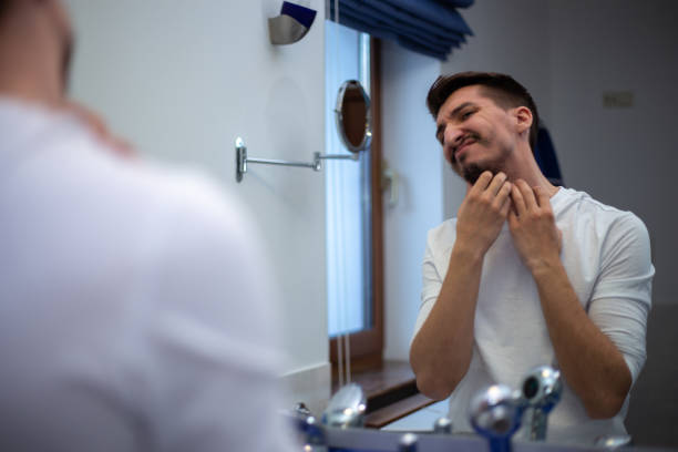 istock A guy with a patchy beard looks in the mirror 1355702885