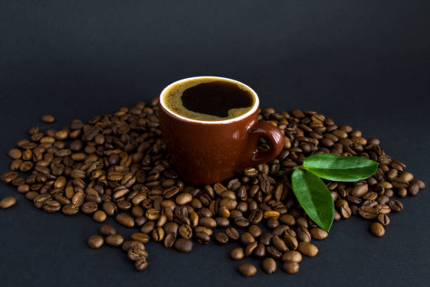 istock Coffee cup and roasted coffee bean on the black background.  Close-up.Copy space. 1355703844