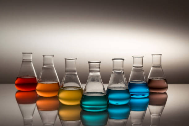 istock Scientific laboratory glass erlenmeyer flask filled with colorful liquid forming rainbow. 1355703972