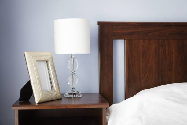 istock Bedroom, bedside table with lamp and picture frame 1355705396