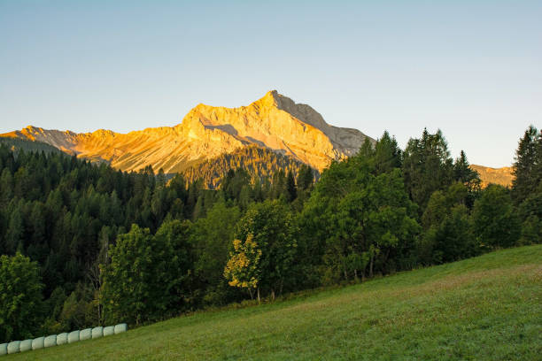 Dawn breaks over Monte Bivera near Sauris di Sopra, Udine Province, Friuli-Venezia Giulia, north east Italy. Late September