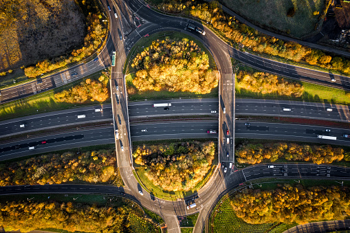 Aerial view of a motorway roundabout junction in a countryside environment