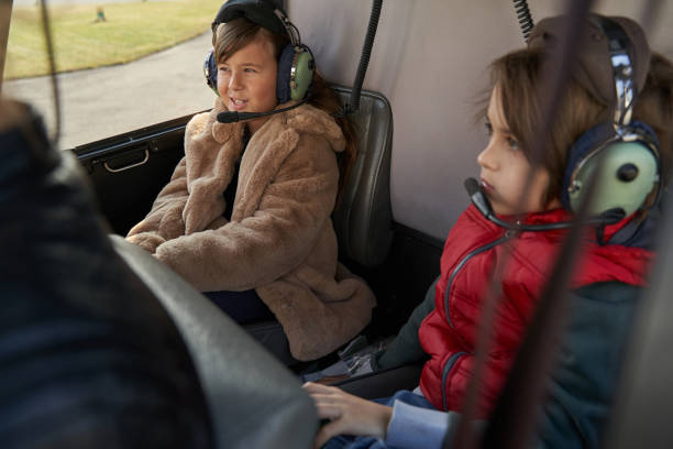 istock Kids in protective gear having a flight on a helicopter 1355710059
