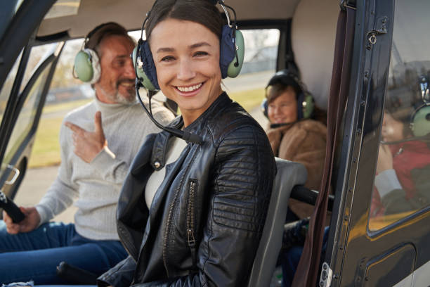 istock Attractive lady having a helicopter flight with husband and kids 1355710060