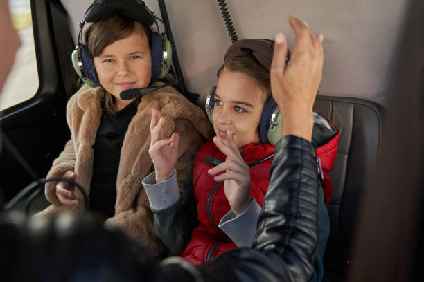 istock Contented kids in safety gear having a helicopter ride 1355710076