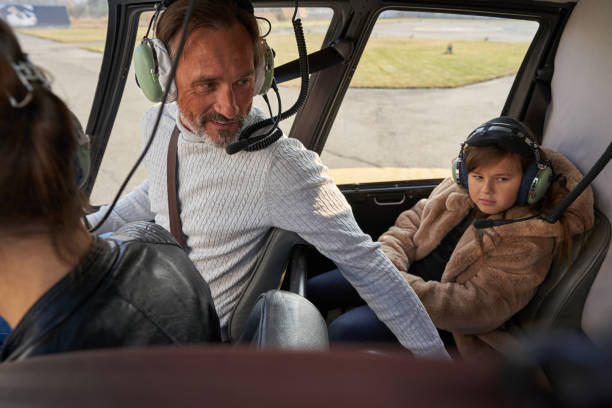 istock Helicopter aviator making sure of passenger well-being 1355710094