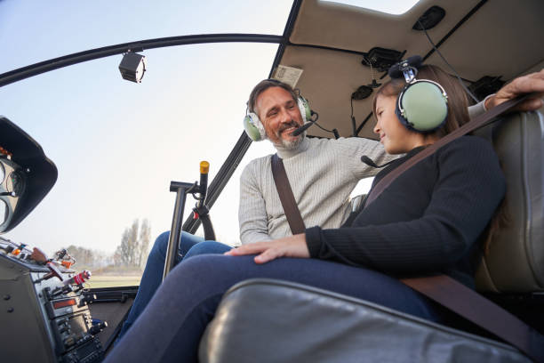 istock Experienced adult taking a kid on helicopter flight 1355710101