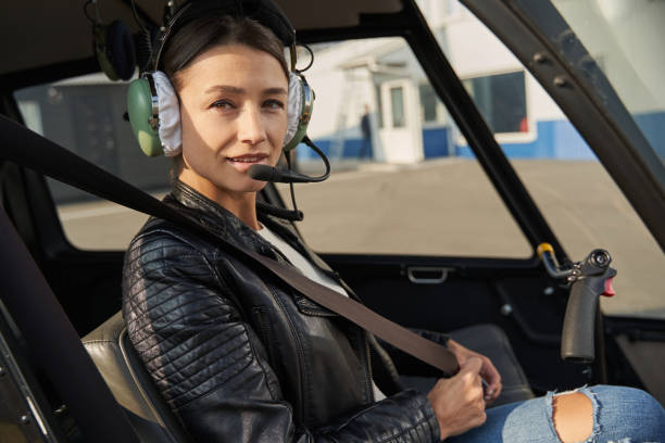 istock Charming lady in pilot gear preparing to fly a copter 1355710137
