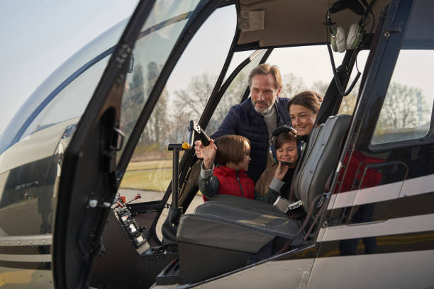 istock Loving parents bringing their children on a helicopter ride 1355710205