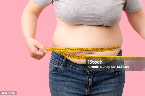 Fat Girl With Overweight Checking Out His Weight Stock Photo - Download Image Now - Obesity, Overweight, Women
