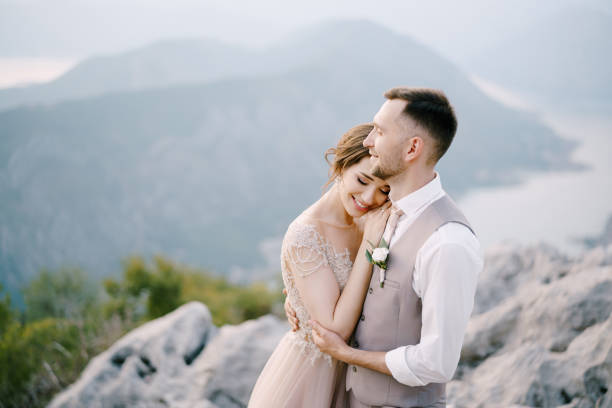 istock Smiling groom embraces bride on the mountain. Portrait 1355714468