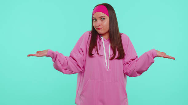 istock Confused pretty girl feeling embarrassed about ambiguous question, having doubts, no idea, clueless 1355714690