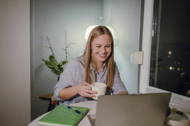 istock Young woman working late at home on laptop 1355716557