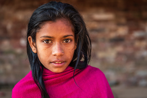 Portrait of young Nepali girl, she lives in Bhaktapur. Bhaktapur is an ancient town in the Kathmandu Valley and is listed as a World Heritage Site by UNESCO for its rich culture, temples, and wood, metal and stone artwork.