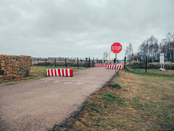istock Road checkpoint with STOP sign. Peacekeeping Force Post. Blocking the road with concrete blocks 1355720844