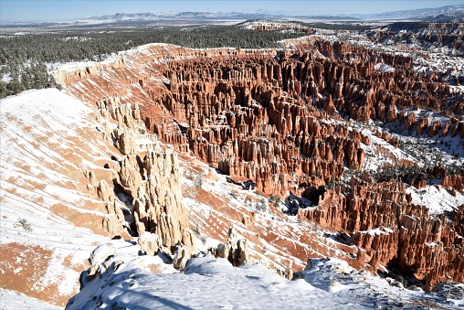 The landscape of Bryce Canyon National Park is accented with a layer of snow as seen from Inspiration Point during autumn.