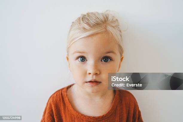 Child Girl Cute Blonde Hair Baby At Home Toddler Looking At Camera Portrait 3 Years Old Kid Family Lifestyle Stock Photo - Download Image Now