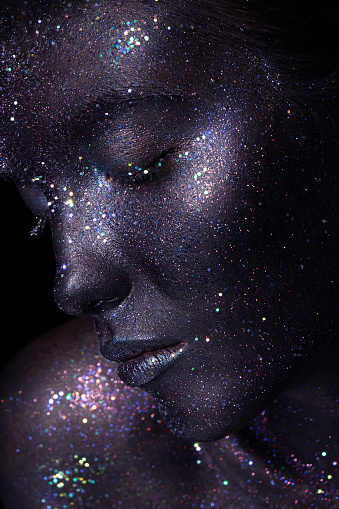 Portrait of beautiful woman with art glitter makeup on her face