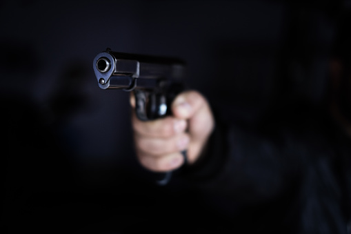 Violencia con armas de fuego con pistola negra photo