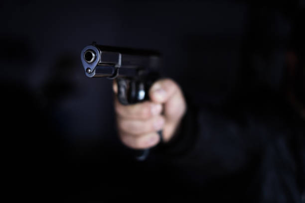 Black Pistol Gun Violence Close-up of black pistol in hand. firing stock pictures, royalty-free photos & images