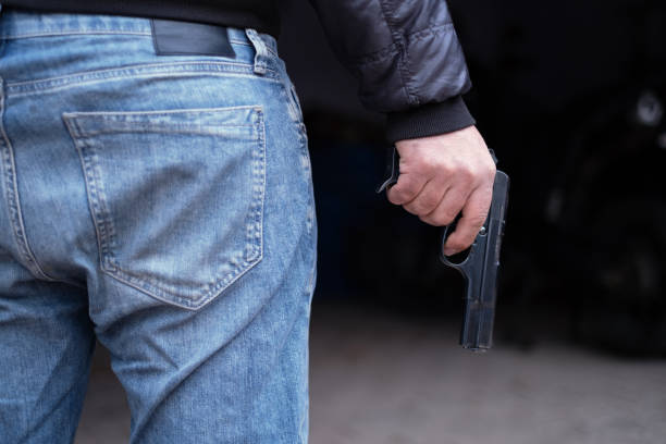 istock Gun in a Man's Hand 1355729618