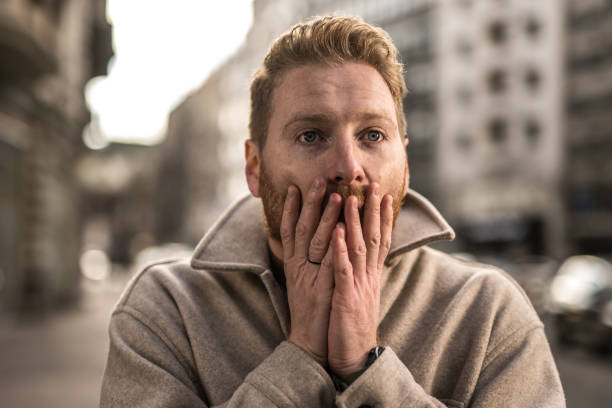 istock Shocked young man in the city. 1355732896