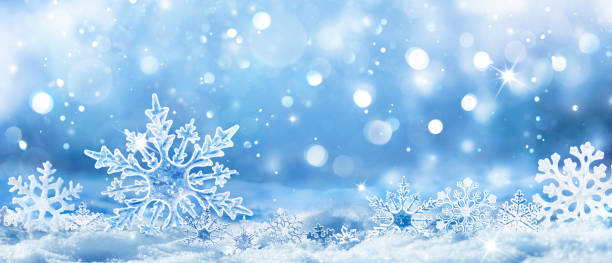 Snowflakes On Snow - Christmas And Winter Background - Natural Snowdrift Close Up With Abstract Light stock photo