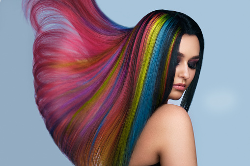 Portrait of beautiful woman with multi-colored hair and creative make up and hairstyle.