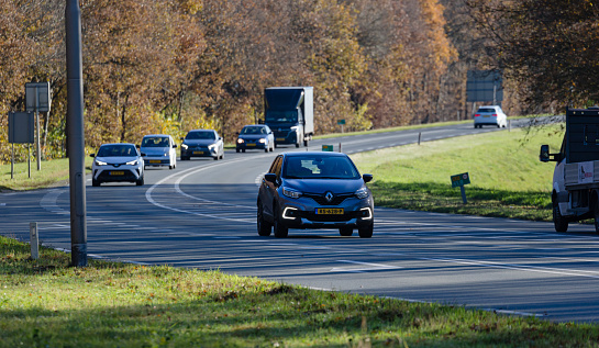 Wierden, Twente, Overijssel, Netherlands, november 22nd 2021, a Dutch gray 2017 Renault 1st generation Captur 'TCe 90' and other traffic driving on the N35 road at Wierden ; the Captur is a subcompact crossover SUV made by French, Boulogne based manufacturer Renault since 2013