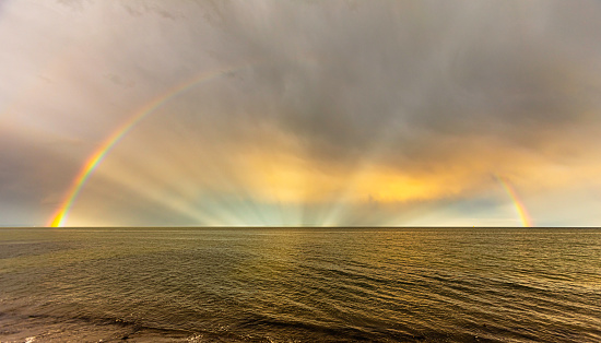 A rainbow is a meteorological phenomenon that is caused by reflection, refraction and dispersion of light in water droplets resulting in a spectrum of light appearing in the sky. It takes the form of a multicoloured circular arc. Rainbows caused by sunlight always appear in the section of sky directly opposite the Sun.g