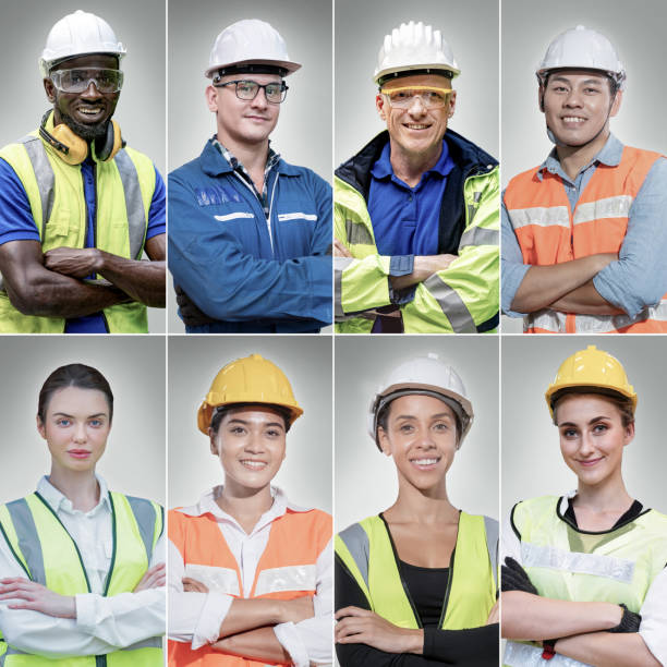 istock group workers men and women engineering standing with confident with blue working suite dress and helmet in front of white background. smart industry worker operating. Diversity of people of industry. 1355747592