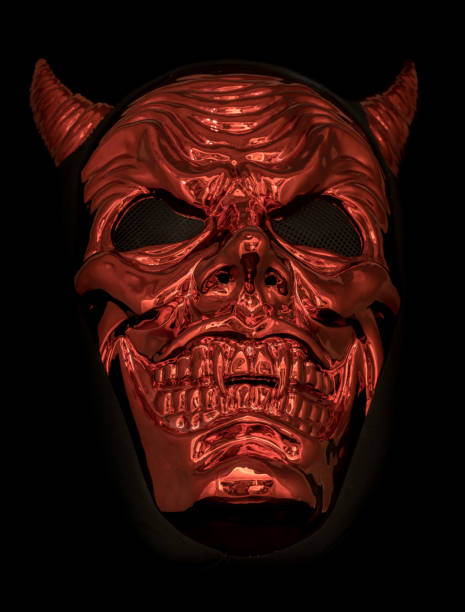 Metallic Red Devil Mask Isolated Against Black Background Metallic Red Devil Mask Isolated Against Black Background devil costume stock pictures, royalty-free photos & images