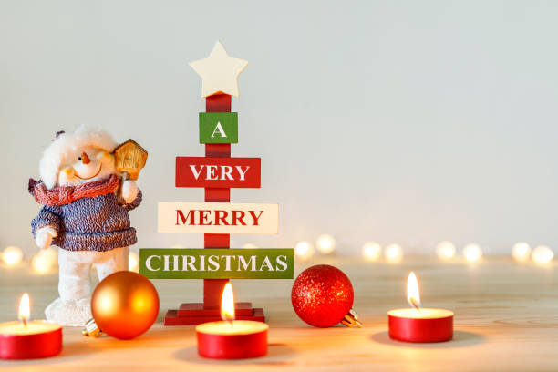istock Christmas decorations on wooden table with defocused holiday lights in background. Copy space 1355759209