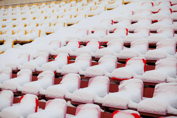 istock Plastic seats in a row at the stadium are covered with snow snow. 1355759273