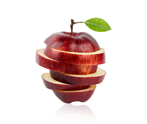 istock Red sliced apple close-up isolated on white background. 1355760126