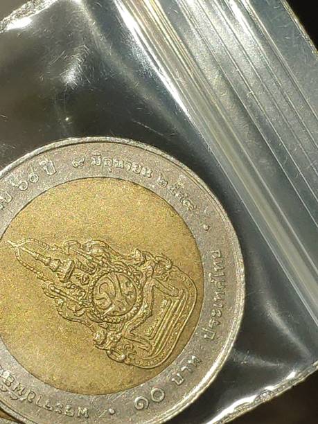 istock Thai baht (coin), In hand holding, Closeup shot. 1355766940