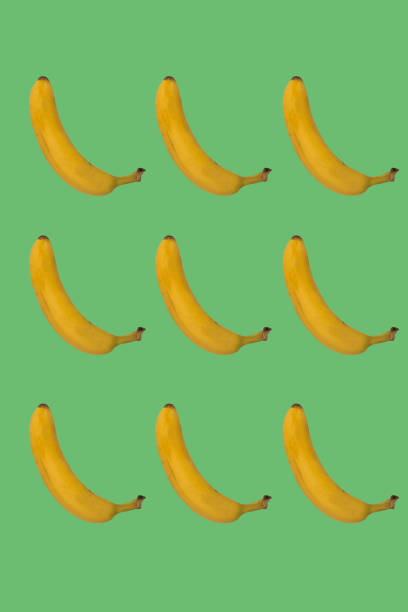 istock yellow ripe banana pattern on green background 1355771129
