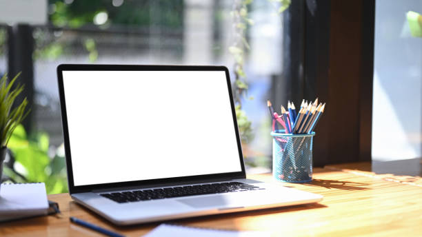 istock Close up computer laptop with empty screen and pencil holder on wooden table. 1355771451