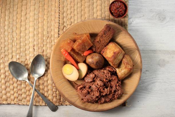 GudegJogja Gudeg. A Signature and Legendary Dish from Yogyakarta Indonesia. Jack Fruit Stew Accompanied with Spicy Stew of Cattle Skin Crackers and Brown Eggs, Tofu, Tempeh, and Sambal. gudeg stock pictures, royalty-free photos & images