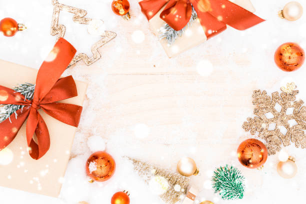 istock Christmas frame. Winter wooden decoration background. Xmas board with old rustic wall, white frozen snow, golden balls and gift box. Top view with copy space. 1355773840