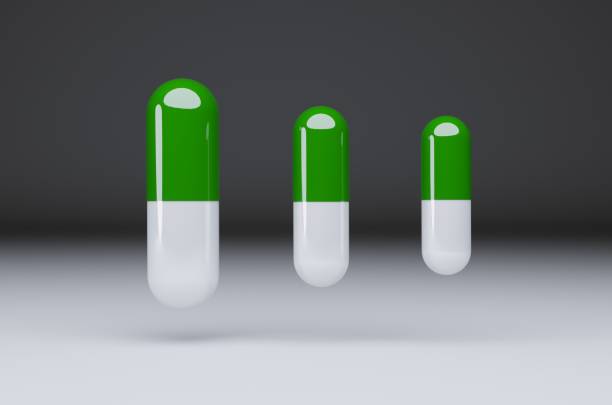 istock Green and white herbal capsules are used for COVID-19 1355774059