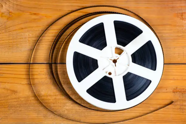 Old Film Reel on the Wooden Planks Background closeup