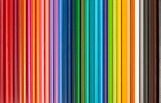 Set of colorful pencils on pink background.