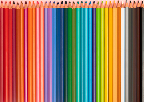 Multi-colored wooden sticks Wooden colouring pencils on white background