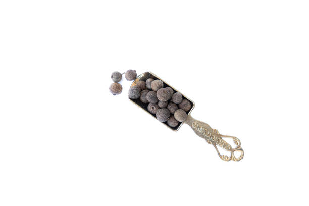 A pile of whole allspice, jamaica peppe isolated on white background