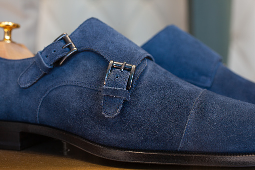 Close up of a blue pair of fashion suede leather men shoes