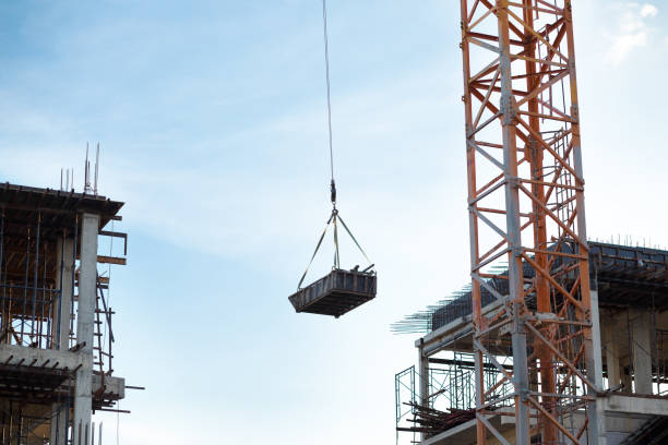 istock Crane is lifting a barrow on conctruction site in Bangkok 1355786678