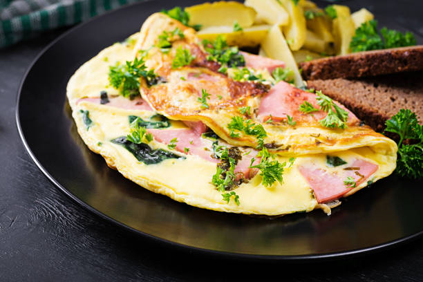 istock Omelet with boiled sausage and herbs, served with fermented cucumbers and bread. Rustic cuisine. Omelette. 1355787630